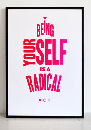 framed poster that says being yourself is a radical act in pink ink.